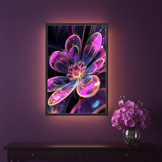Framed abstract floral artwork on a purple wall with a vase of pink flowers below.