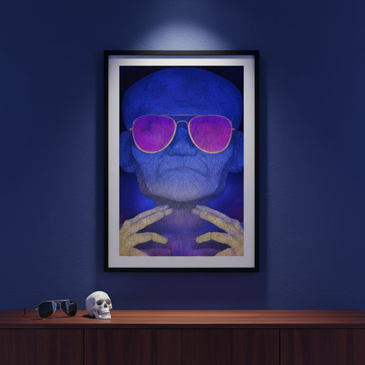 Framed artwork of a person wearing sunglasses on a dark blue wall with a skull and sunglasses on a wooden surface below.